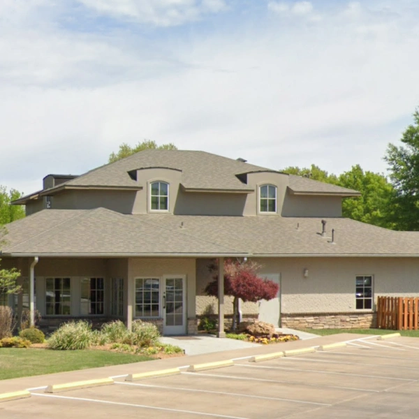 Modern two-story residential home with landscaping and driveway in suburban setting.