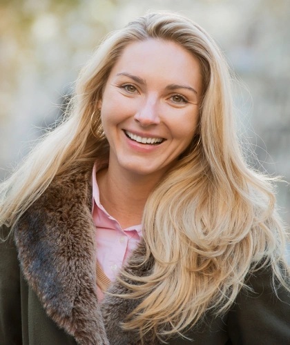Smiling woman with blonde hair in professional headshot for Bartlesville cosmetic dental practice.